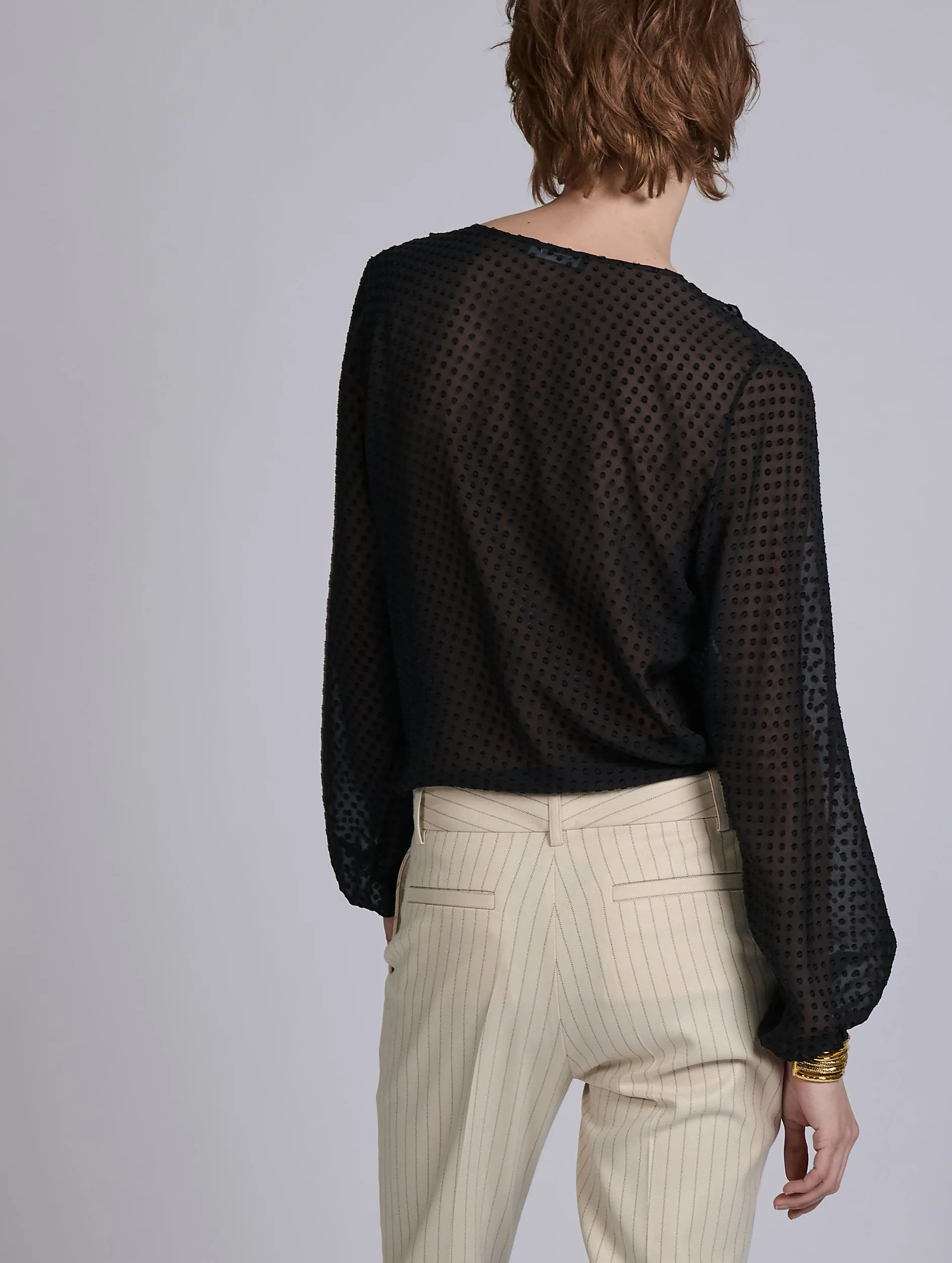 Black ruffled blouse in jacquard plumetis Stretchable Weave